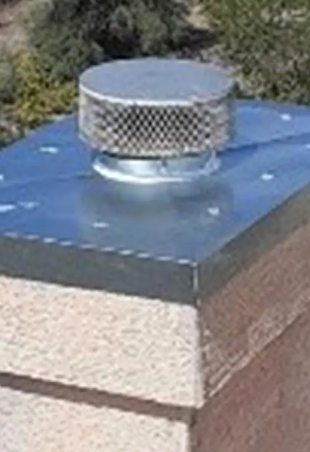 Stainless chase cover and cap on a prefab chimney