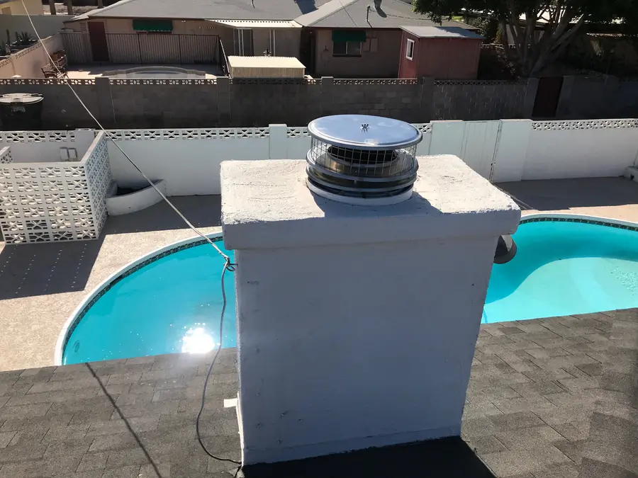Chimney cap on a prefab chimney beside a pool