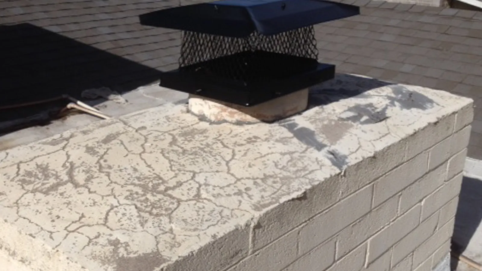 Cracked, weathered chimney crown before sealing