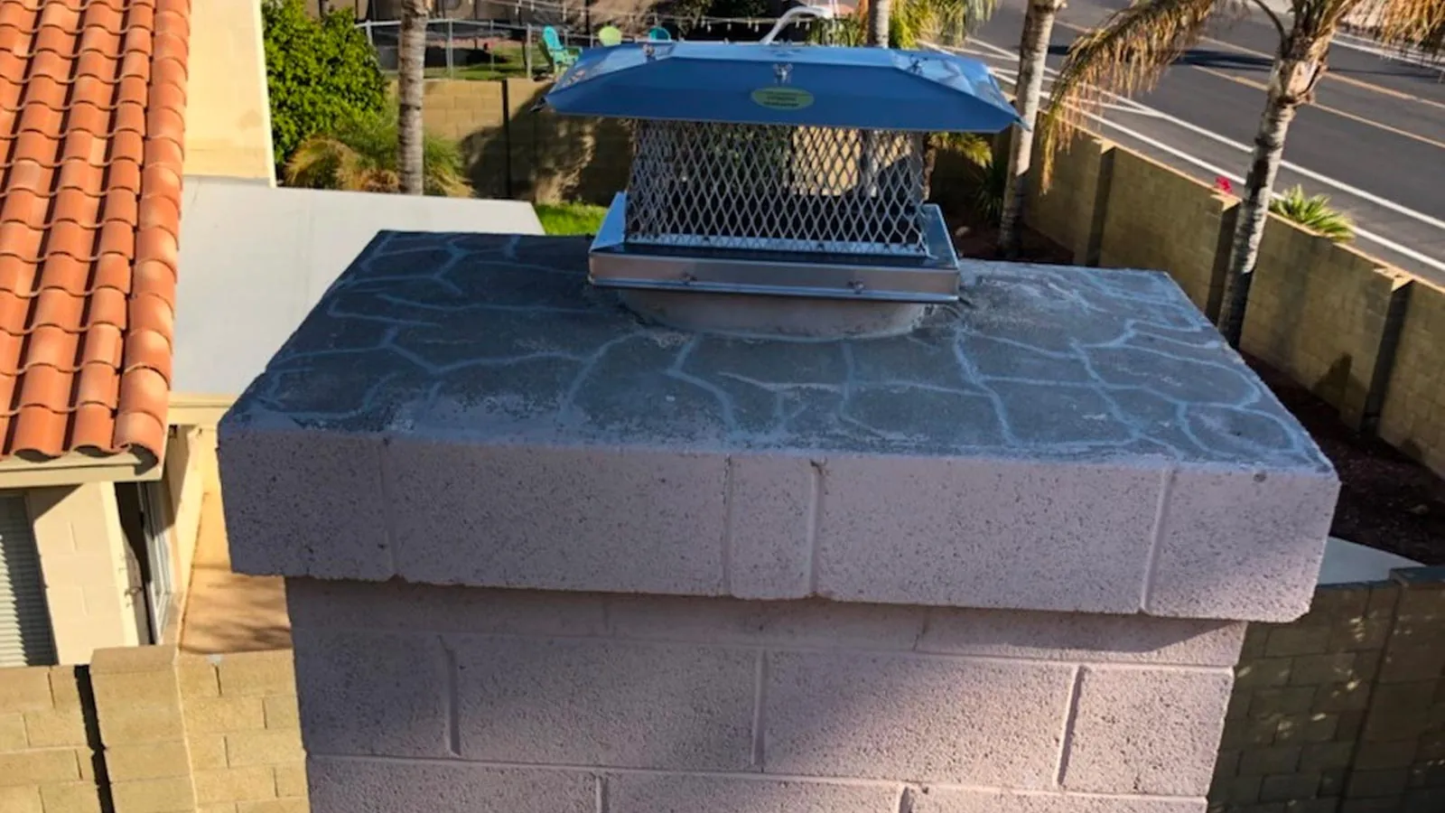 Repaired chimney crown with a new chimney cap