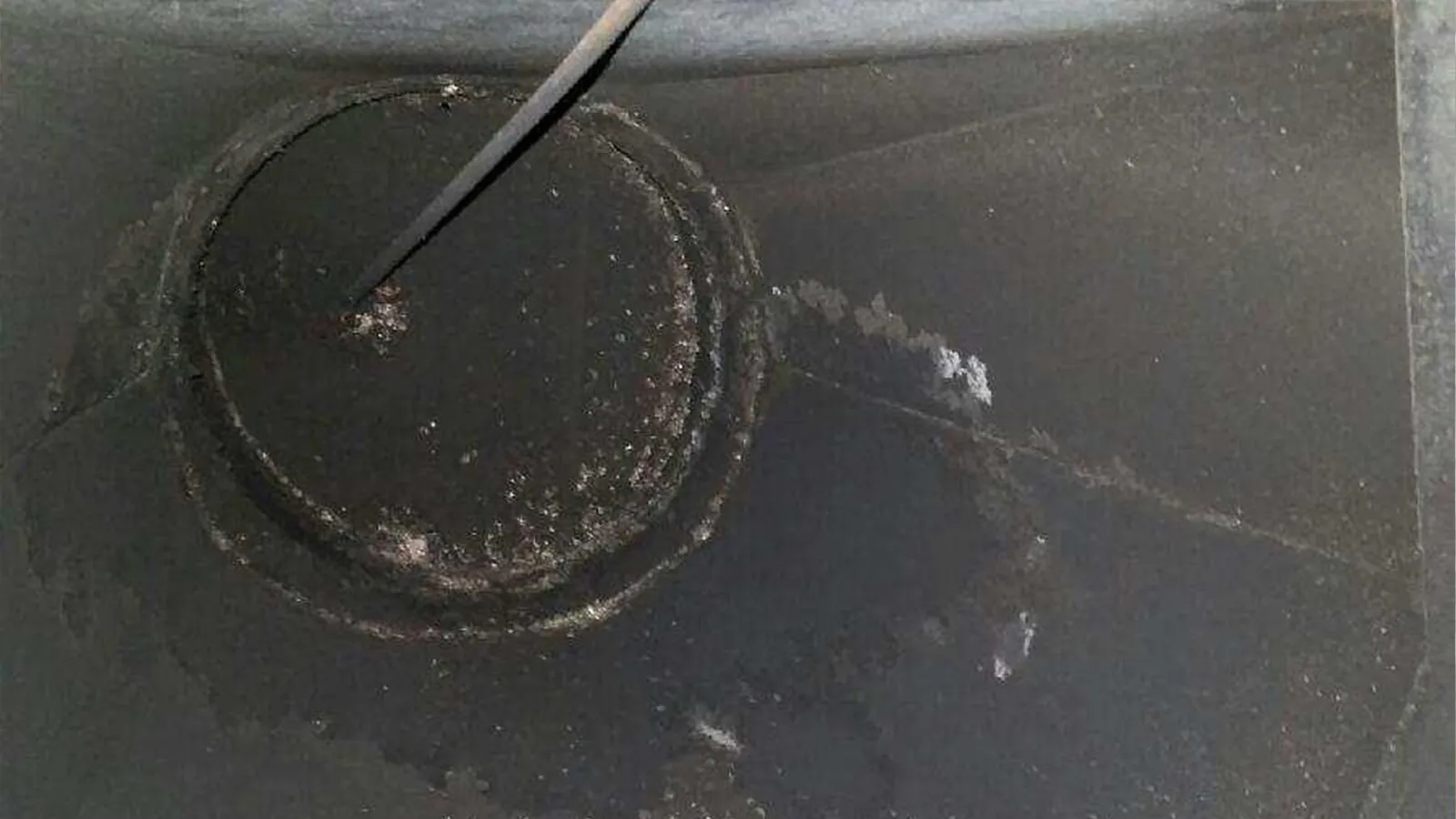 Chimney flue coated with creosote before cleaning