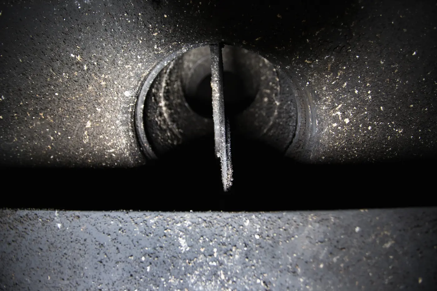 Chimney flue and damper coated in soot before cleaning