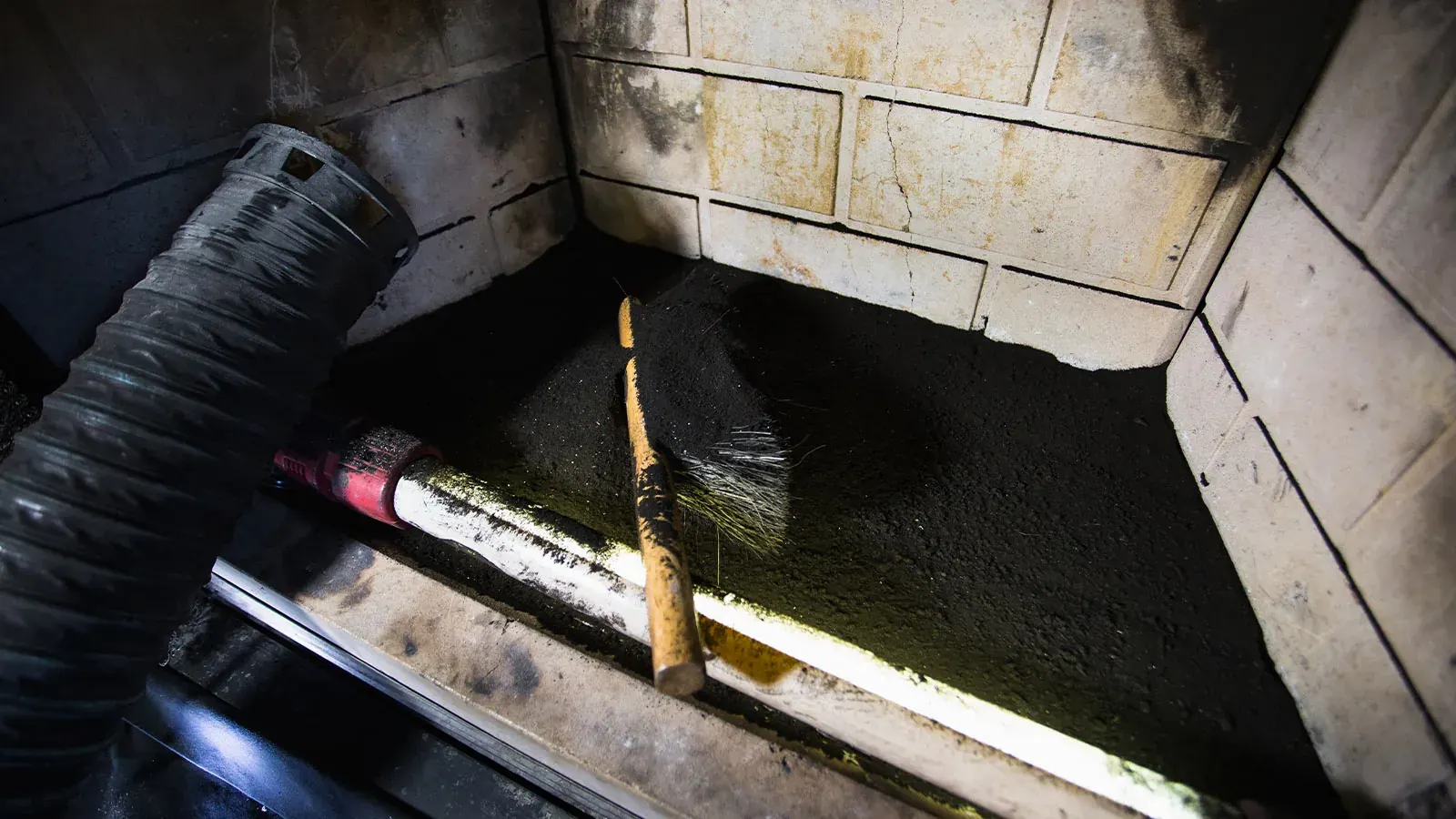 Creosote buildup inside a firebox during cleaning