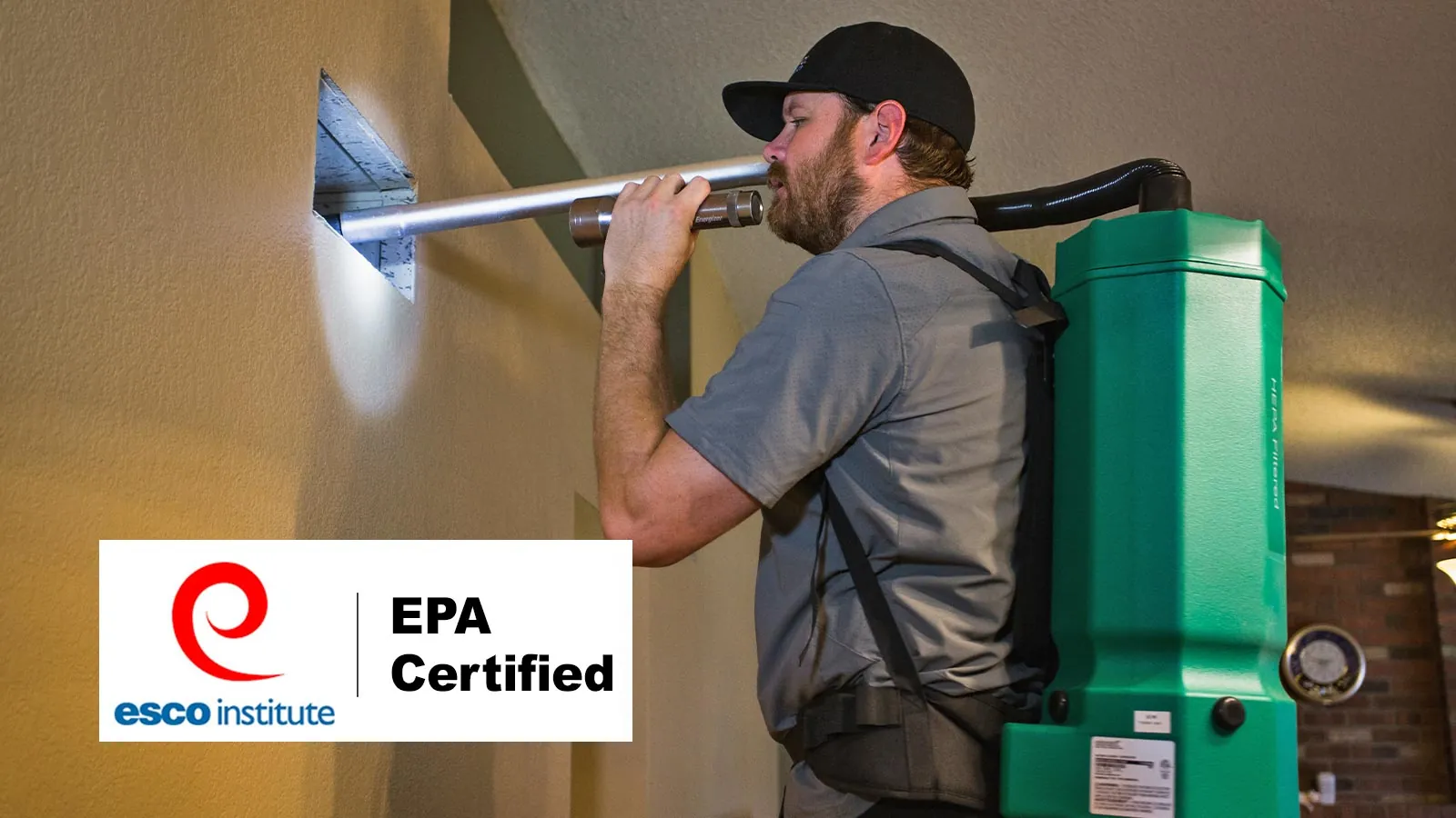 EPA-certified technician cleaning an air vent with a HEPA backpack vacuum