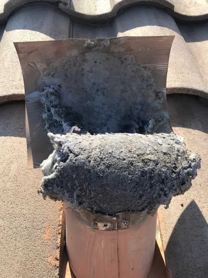 Lint packed into a roof dryer vent