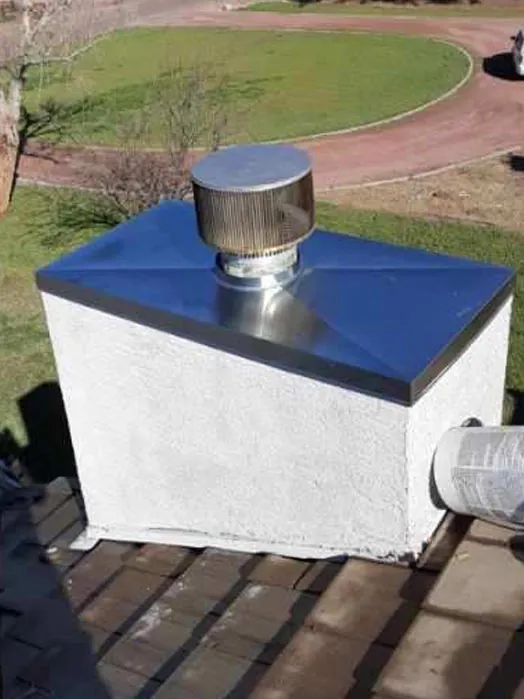 New metal chase cover and cap on a prefab chimney