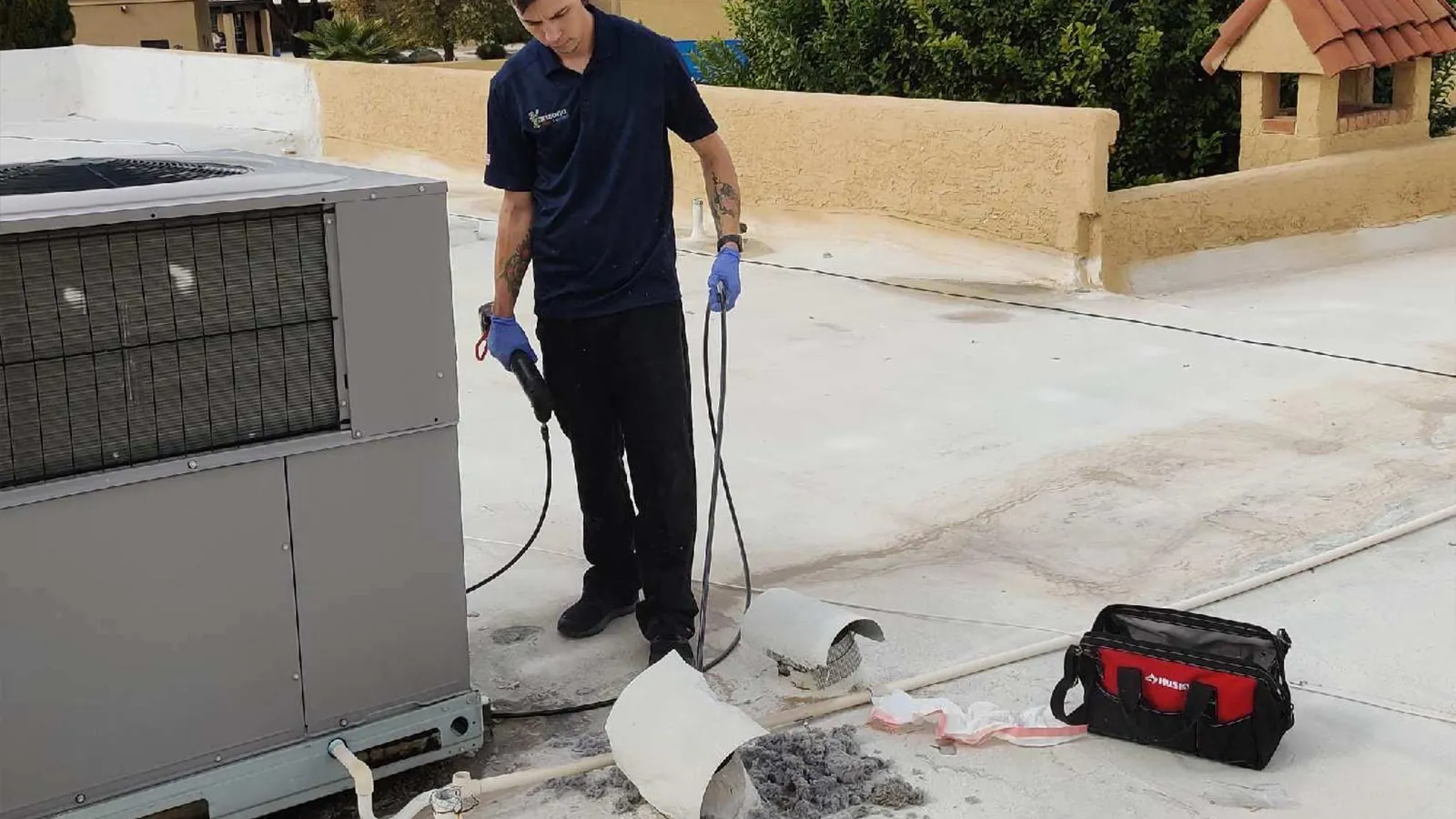 Arizona Chimney and Air Ducts technician cleaning a dryer vent line in a Phoenix area home